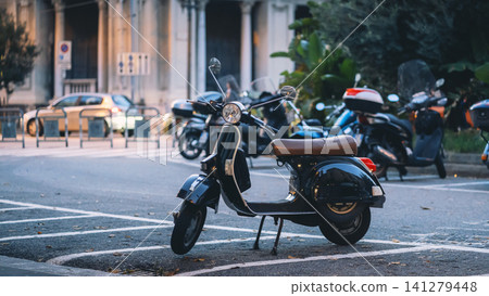 Messina, Italy - Nov 5 2018, panoramic view of one of the streets of Messina where a scooter is lonely parked along with other vehicles, the background is blurred, at daytime, Messina, Italy Messina, Italy - Nov 5 2018, panoramic view of one of the streets of Messina where a scooter is lonely parked along with other vehicles, the background is blurred, at daytime, Messina, Italy 141279448
