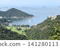 Scenic coastal landscape with golf course and sailboats in a bay Scenic coastal landscape with golf course and sailboats in a bay 141280113