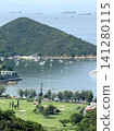 Scenic coastal landscape with a golf course and sailboats in a bay Scenic coastal landscape with a golf course and sailboats in a bay 141280115