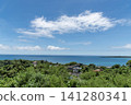 From the hilltop, you can see the trees and buildings in the foreground and the clearly defined horizon of the tropical sea. 141280341