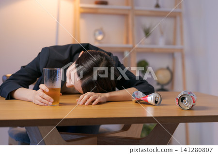 A woman in a suit who is passed out drunk. A woman in a suit who is passed out drunk. 141280807