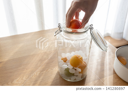 Making plum wine 141280897
