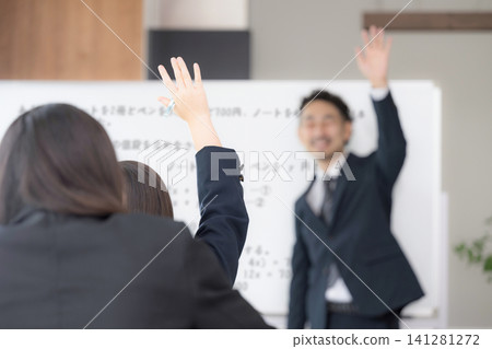 A scene from a school classroom: a junior high school student raising their hand in class or at a cram school, a female high school student, and a teacher, looking at the blackboard. 141281272
