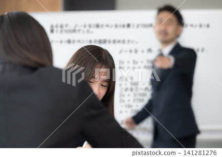 A female high school student is reprimanded by a teacher for talking during class; school education and classroom guidance scenes; images of internal evaluation and student guidance. A female high school student is reprimanded by a teacher for talking during class; school education and classroom guidance scenes; images of internal evaluation and student guidance. 141281276