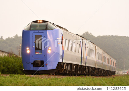 The Super Hokuto limited express train running along the Muroran Main Line at dusk. The Super Hokuto limited express train running along the Muroran Main Line at dusk. 141282625