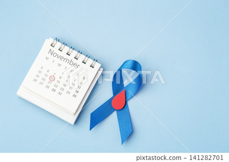 World Diabetes Day on November 14 concept, Blue ribbon with a red blood drop over a light blue background with copy space World Diabetes Day on November 14 concept, Blue ribbon with a red blood drop over a light blue background with copy space 141282701