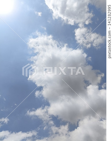 Bright blue sky with fluffy white clouds 141282995