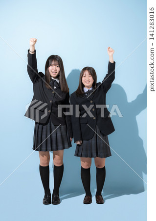 Japanese high school and junior high school girls strike a determined pose against a light blue background, looking towards the future. (Full body shots) Japanese high school and junior high school girls strike a determined pose against a light blue background, looking towards the future. (Full body shots) 141283016