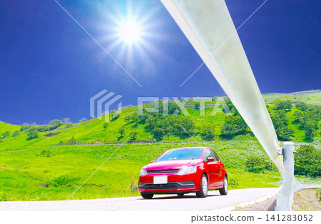 A red car driving across a plateau under the sun (low angle) A red car driving across a plateau under the sun (low angle) 141283052