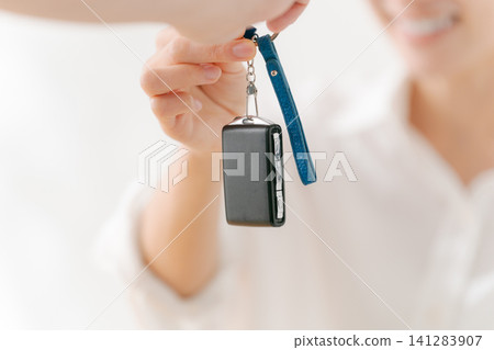 Woman receiving car keys 141283907