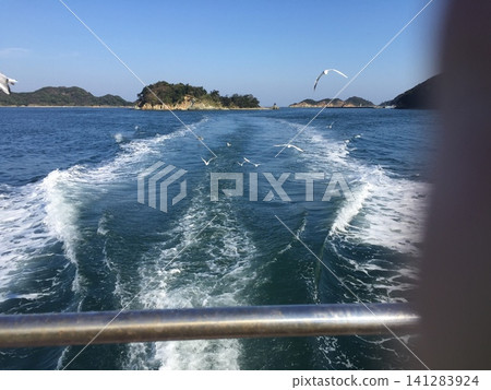 The wake of a ship sailing on the sea and the scenery of islands 141283924