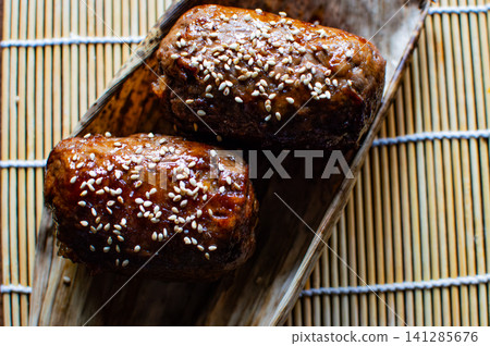 Meat-wrapped rice balls placed on bamboo leaves; rice balls;俵型 (tawaragata) shaped rice balls Meat-wrapped rice balls placed on bamboo leaves; rice balls;俵型 (tawaragata) shaped rice balls 141285676