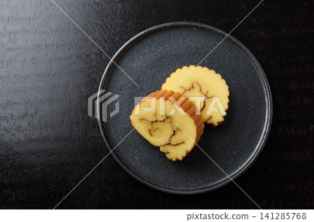 New Year's dishes: Datemaki (rolled omelet) - Black background New Year's dishes: Datemaki (rolled omelet) - Black background 141285768