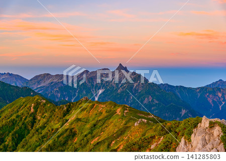 Early autumn morning, a view from near Enzanso mountain hut on Mount Tsubakuro, showing Mount Yarigatake, the Hotaka mountain range, and the ridgeline leading to Mount Otensho bathed in the pink glow of the morning light. Early autumn morning, a view from near Enzanso mountain hut on Mount Tsubakuro, showing Mount Yarigatake, the Hotaka mountain range, and the ridgeline leading to Mount Otensho bathed in the pink glow of the morning light. 141285803