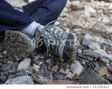 Dirty hiking shoes after trekking in mountains Dirty hiking shoes after trekking in mountains 141285821