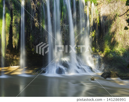 Powerful waterfall surrounded by nature Powerful waterfall surrounded by nature 141286991