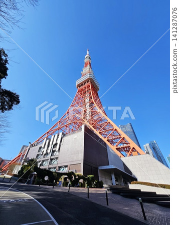Low angle view of Tokyo Tower against clear blue sky in Tokyo, Japan. Low angle view of Tokyo Tower against clear blue sky in Tokyo, Japan. 141287076