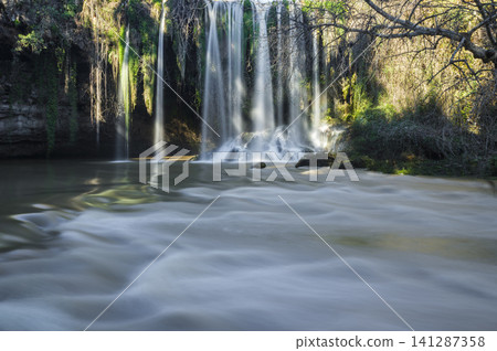 Powerful waterfall surrounded by nature Powerful waterfall surrounded by nature 141287358