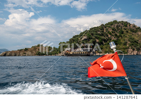 urkish flag on boat with scenic island coast background urkish flag on boat with scenic island coast background 141287641
