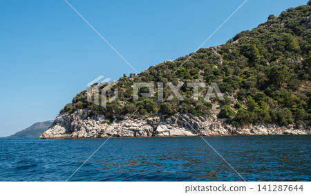 White rocky cliffs and green mountains in Marmaris Turkey White rocky cliffs and green mountains in Marmaris Turkey 141287644