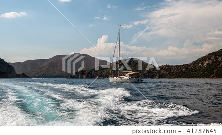 Luxury motor yacht sailing near rocky island in Marmaris Turkey Luxury motor yacht sailing near rocky island in Marmaris Turkey 141287645