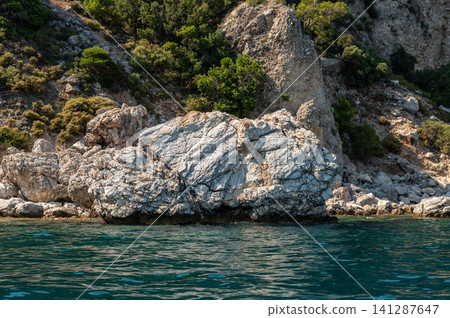 White rocky cliffs and green mountains in Marmaris Turkey White rocky cliffs and green mountains in Marmaris Turkey 141287647