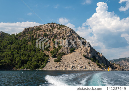 Beautiful sea wave trace from boat with mountain coast 141287649