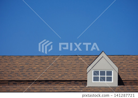 orange roof of the house with white window frame in dark blue clear sky 141287721