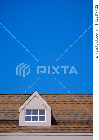 orange roof of the house with white window frame in dark blue clear sky 141287722
