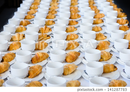 line of croissant waiting for coffee break 141287783