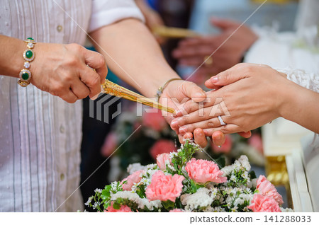 pouring holy water in thai wedding pouring holy water in thai wedding 141288033