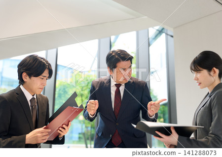 A boss who blames his subordinates in a meeting A boss who blames his subordinates in a meeting 141288073