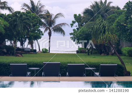 beach beds at seaside pool in the resort somewhere in Thailand beach beds at seaside pool in the resort somewhere in Thailand 141288190