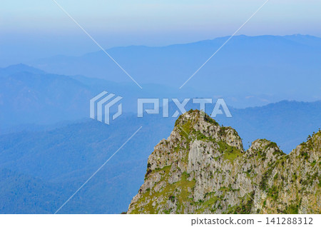 rocky grassland at top of the mountain with blue sky rocky grassland at top of the mountain with blue sky 141288312