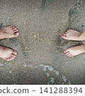 two feets of man and woman stand together on sand, abstract photograph, background, couple 141288394