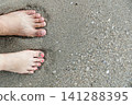 two feets of man and woman stand together on sand, abstract photograph, background, couple 141288395
