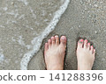 two feets of man and woman stand together on sand, abstract photograph, background, couple 141288396