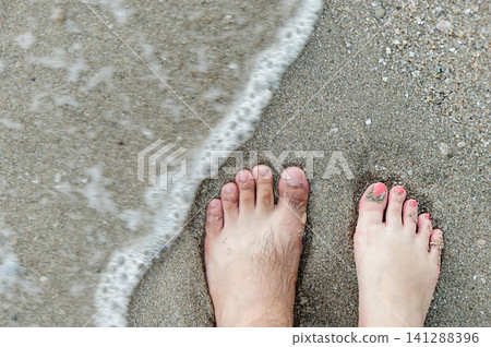 two feets of man and woman stand together on sand, abstract photograph, background, couple two feets of man and woman stand together on sand, abstract photograph, background, couple 141288396