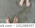 two feets of man and woman stand together on sand, abstract photograph, background, couple 141288397