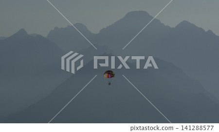 Tourists soaring high above the sea while parasailing 141288577