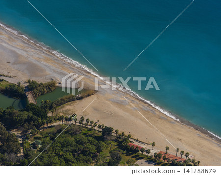 a sandy shore and blue sea 141288679