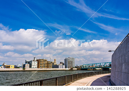 A view along the Nakagawa River in Katsushika under the midsummer sky. A view along the Nakagawa River in Katsushika under the midsummer sky. 141288925