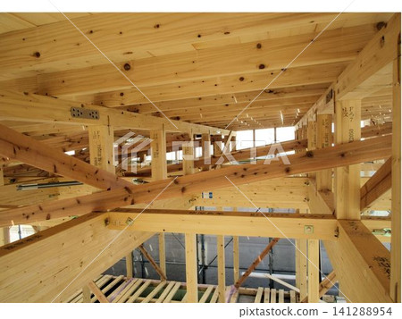 Structural frame of a newly constructed wooden house, with beams and columns assembled. 141288954