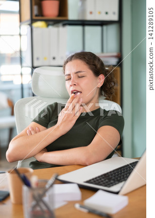 Young woman in dress sleeping sitting at office desk Young woman in dress sleeping sitting at office desk 141289105
