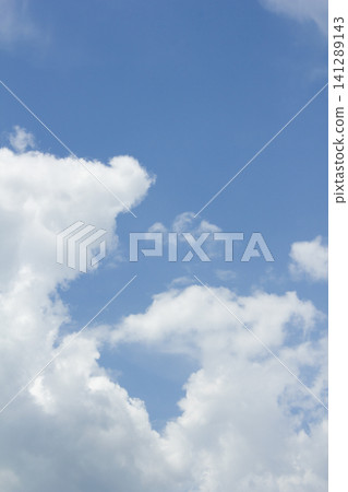 It is a blue sky with fluffy clouds. It is a blue sky with fluffy clouds. 141289143