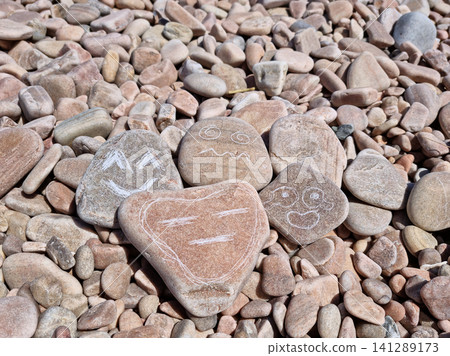 Various facial expressions drawn on pebbles Various facial expressions drawn on pebbles 141289173