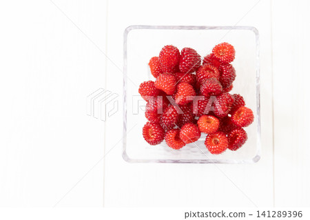Raspberries on a white table Raspberries on a white table 141289396