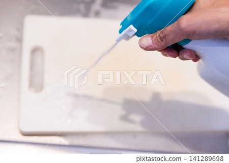 Pour foamy bleach onto a white cutting board. Pour foamy bleach onto a white cutting board. 141289698