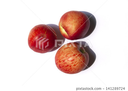 It is a Nectarine on a white background. 141289724