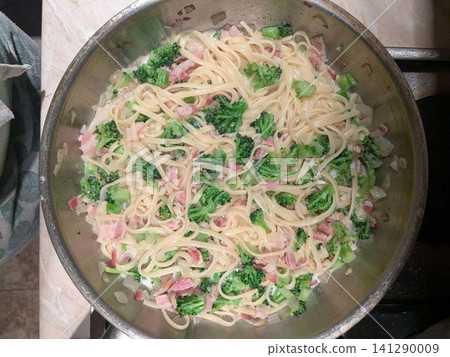Fresh pasta with broccoli and bacon in a skillet Fresh pasta with broccoli and bacon in a skillet 141290009